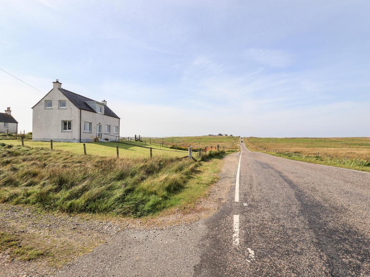a house on the side of a road at Park Cottage in Carinish